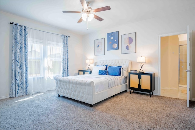 carpeted bedroom with ceiling fan and baseboards