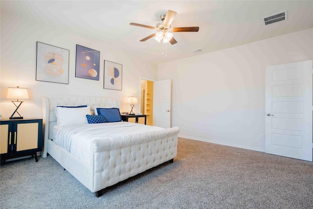 carpeted bedroom with baseboards, visible vents, and a ceiling fan