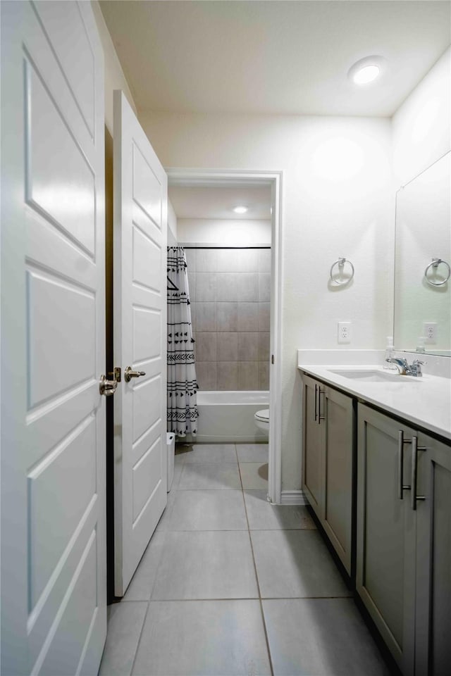 bathroom with shower / bath combo, vanity, toilet, and tile patterned floors