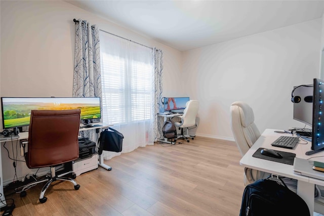 office with light wood-style flooring and baseboards