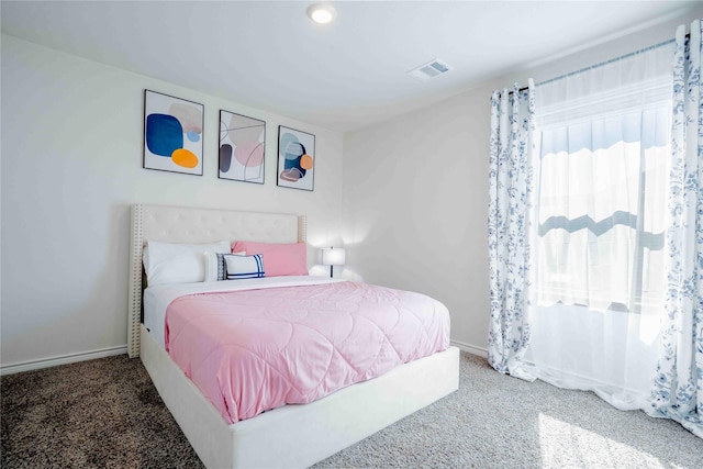 carpeted bedroom featuring baseboards and visible vents