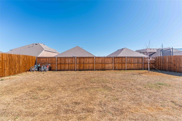 view of yard with a fenced backyard