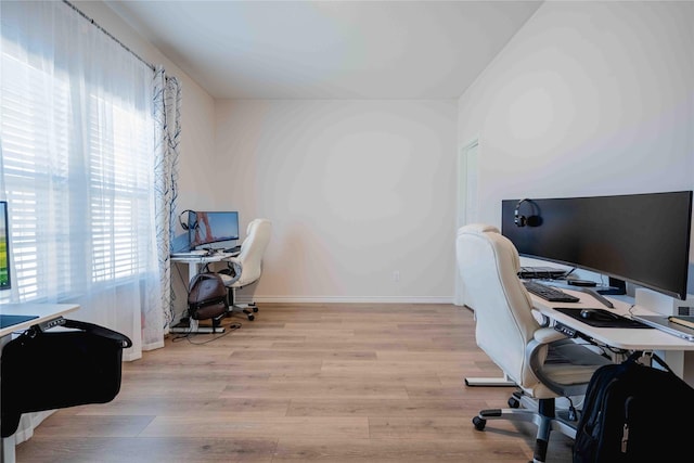 home office with baseboards and wood finished floors