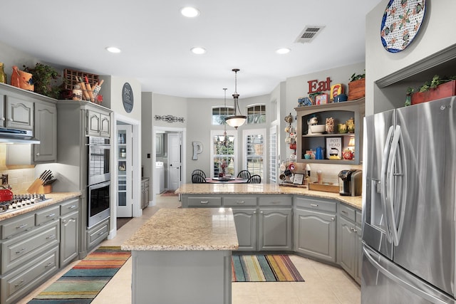 kitchen with stainless steel appliances, under cabinet range hood, visible vents, and gray cabinetry