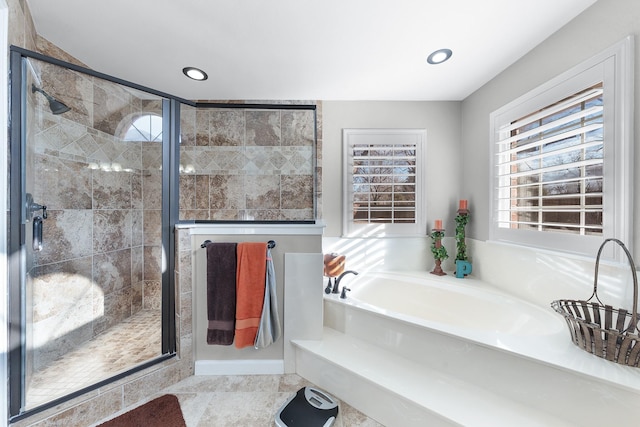 bathroom with recessed lighting, a garden tub, and a shower stall