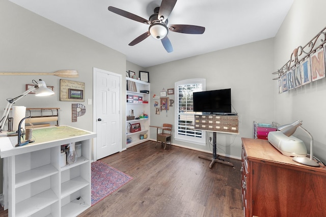 interior space featuring a ceiling fan, baseboards, and wood finished floors