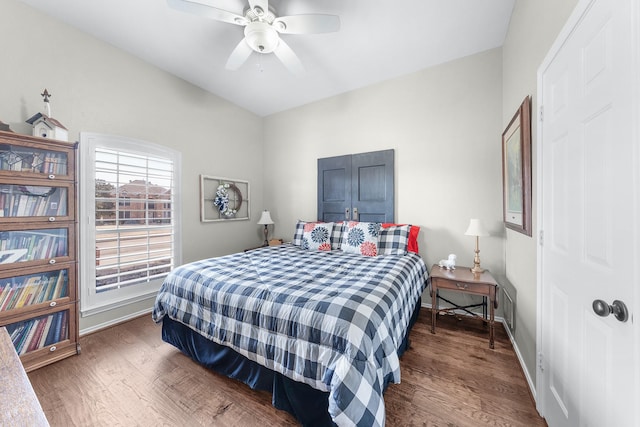 bedroom featuring ceiling fan, wood finished floors, and baseboards