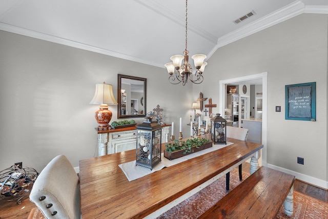 dining room featuring crown molding, lofted ceiling, visible vents, an inviting chandelier, and wood finished floors