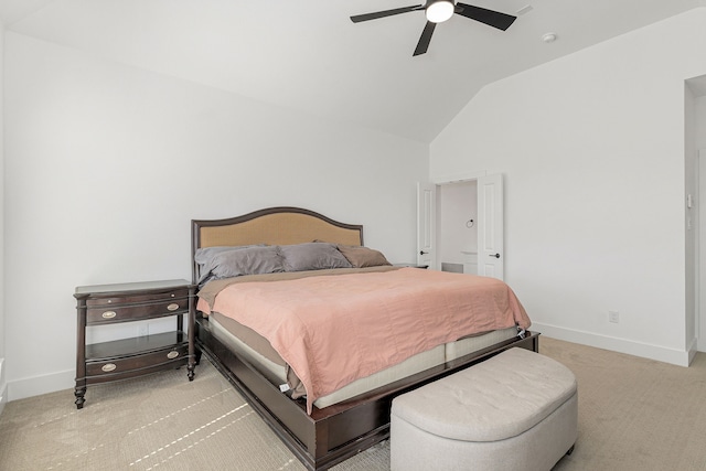 bedroom with a ceiling fan, light colored carpet, vaulted ceiling, and baseboards