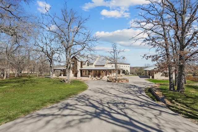 133 E Bozeman Ln, Fort Worth, TX 76108 - view of front facade featuring curved driveway, covered porch, and a front yard