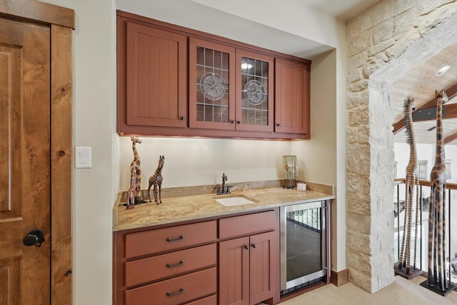 bar featuring indoor wet bar, beverage cooler, and a sink