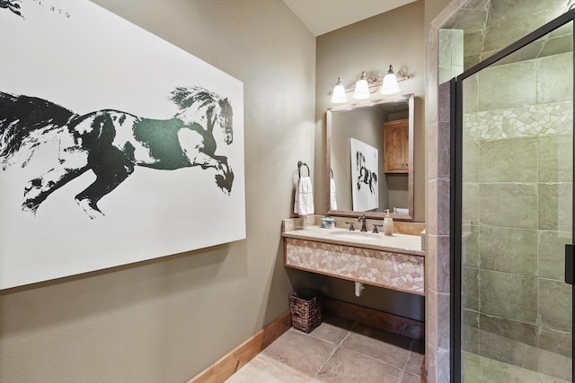 full bathroom with tile patterned floors, a stall shower, vanity, and baseboards