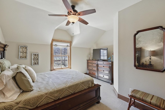 carpeted bedroom with ceiling fan and vaulted ceiling