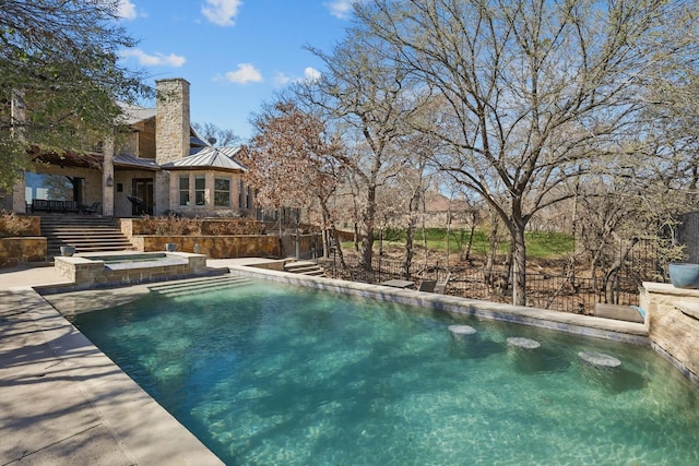 view of swimming pool featuring a pool with connected hot tub