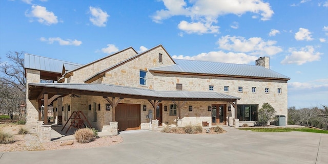 view of front of property with a porch, a garage, and driveway