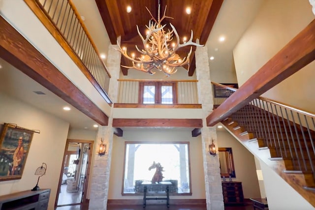 entryway featuring an inviting chandelier, stairs, wood ceiling, french doors, and a towering ceiling