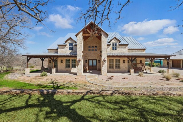 133 E Bozeman Ln, Fort Worth, TX 76108 - back of property with a standing seam roof, a patio, metal roof, and stone siding
