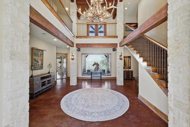 133 E Bozeman Ln, Fort Worth, TX 76108 - foyer entrance with a chandelier, concrete flooring, stairs, a high ceiling, and baseboards
