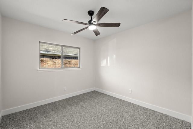 carpeted empty room with a ceiling fan and baseboards