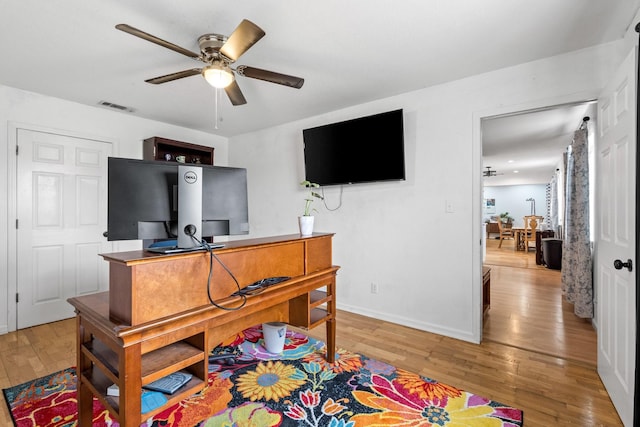 office area with visible vents, baseboards, ceiling fan, and wood finished floors