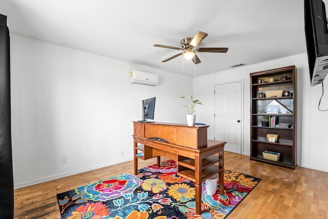 office with ceiling fan, visible vents, wood finished floors, and a wall mounted AC