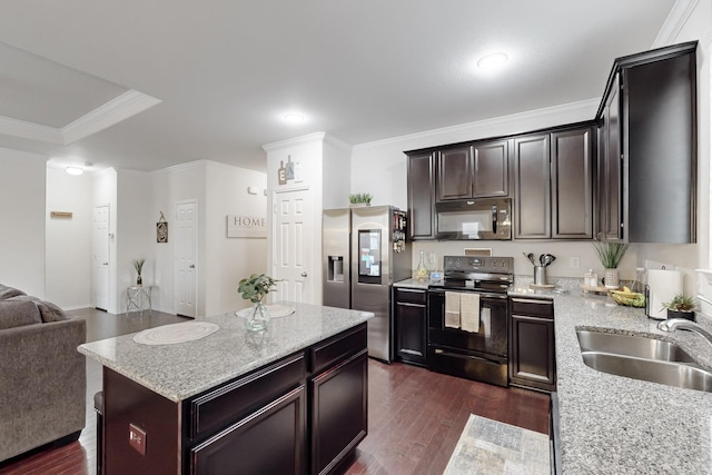 kitchen with dark wood-style floors, open floor plan, crown molding, black appliances, and a sink