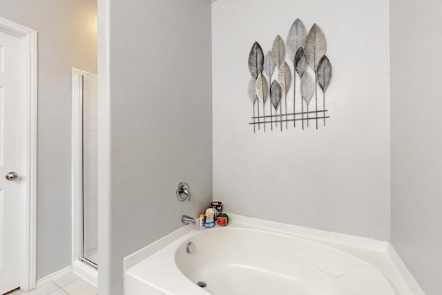 bathroom featuring a stall shower, tile patterned floors, and a bath