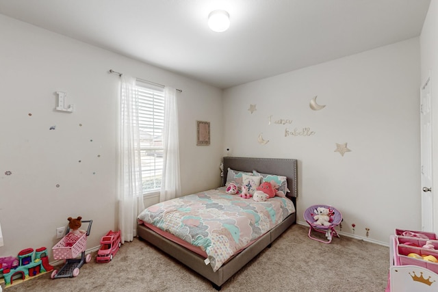 bedroom with baseboards and carpet flooring