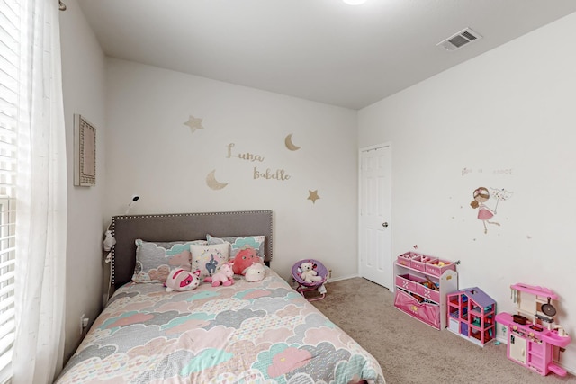 carpeted bedroom featuring visible vents