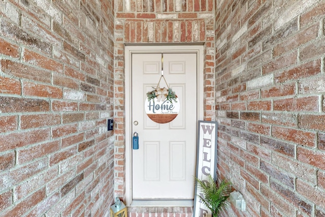 entrance to property with brick siding