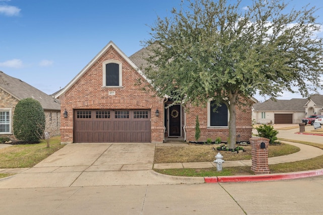 view of front facade featuring concrete driveway and brick siding