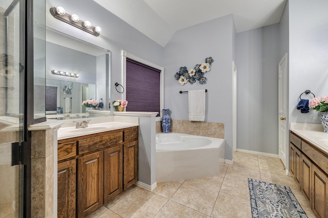 bathroom featuring a bath, a stall shower, tile patterned flooring, and vanity