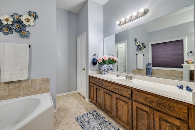 bathroom with a garden tub, tile patterned flooring, and vanity