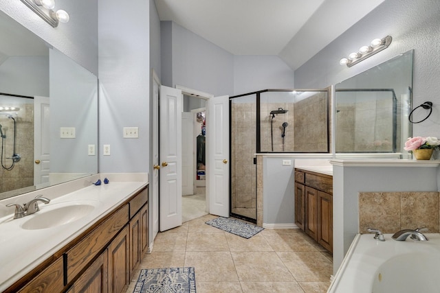 full bath with lofted ceiling, tile patterned floors, a tile shower, and vanity