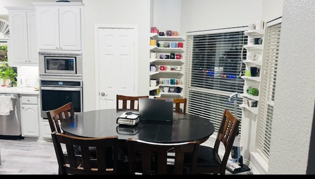 dining room with light wood finished floors