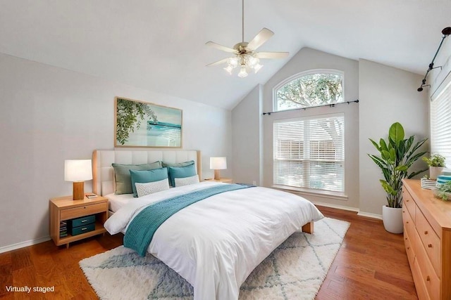 bedroom featuring ceiling fan, baseboards, vaulted ceiling, and wood finished floors