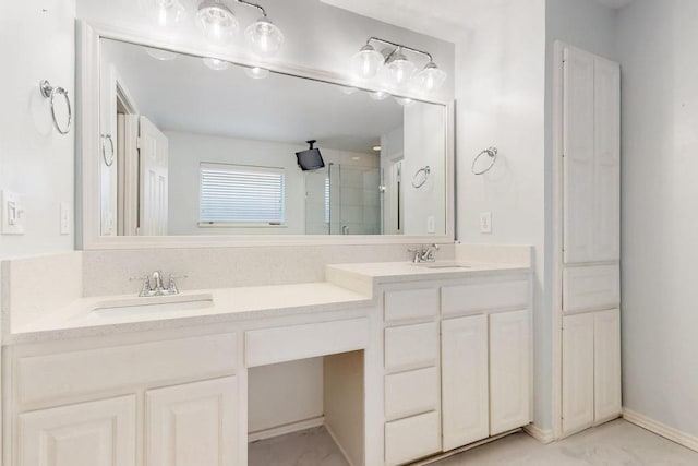 bathroom featuring a stall shower, a sink, baseboards, and double vanity