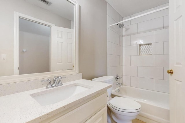 full bathroom featuring washtub / shower combination, visible vents, vanity, and toilet