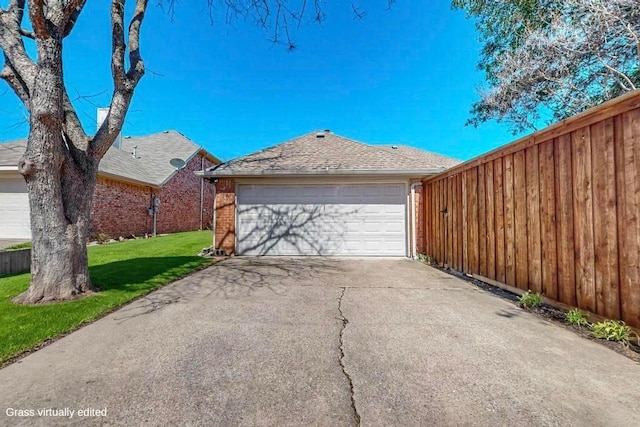 view of front of house featuring brick siding, an attached garage, fence, driveway, and a front lawn