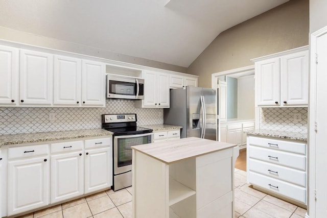 kitchen featuring lofted ceiling, light tile patterned floors, white cabinetry, and appliances with stainless steel finishes