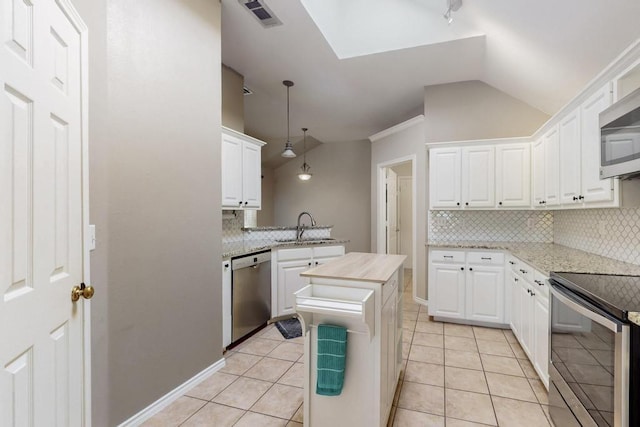 kitchen featuring lofted ceiling, light tile patterned floors, a sink, visible vents, and appliances with stainless steel finishes