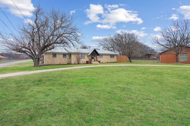 single story home featuring a front yard, fence, and driveway