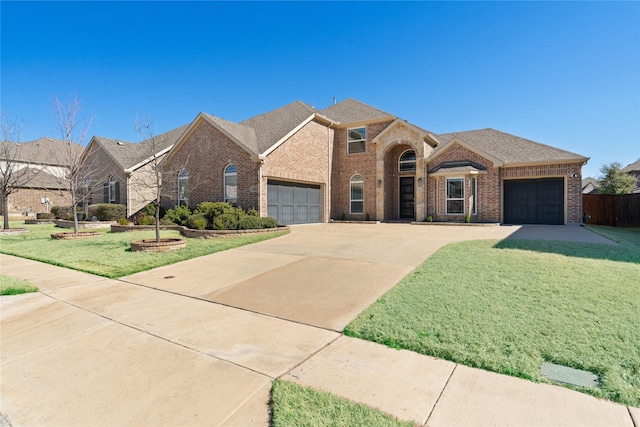 traditional home featuring an attached garage, a front lawn, and brick siding