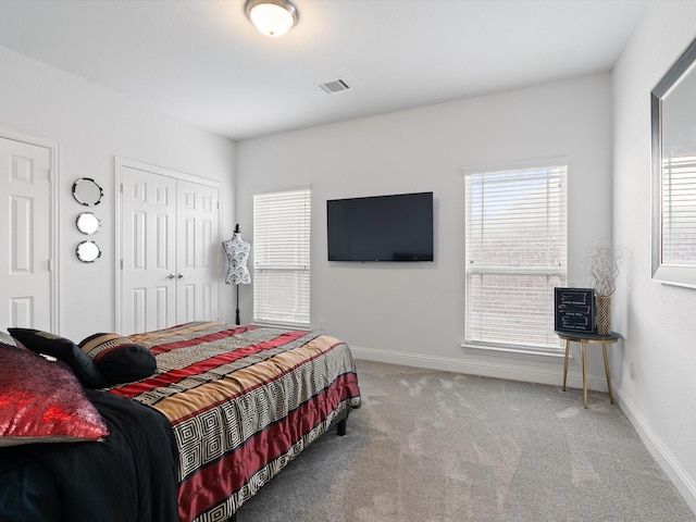 bedroom with carpet, visible vents, and baseboards