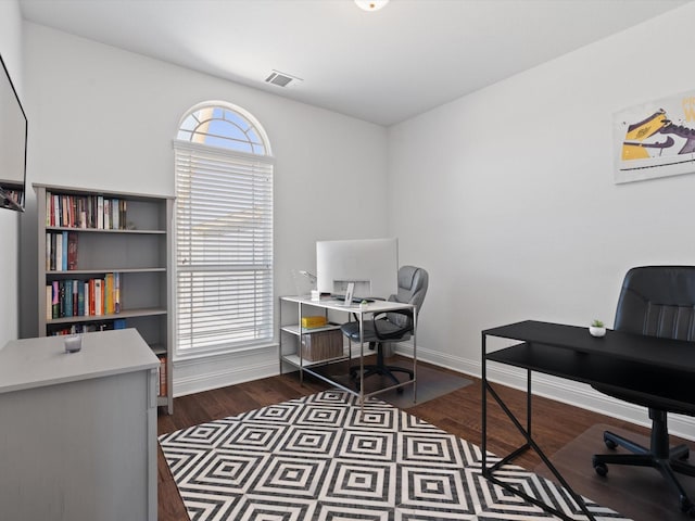 home office featuring baseboards, visible vents, and dark wood-type flooring