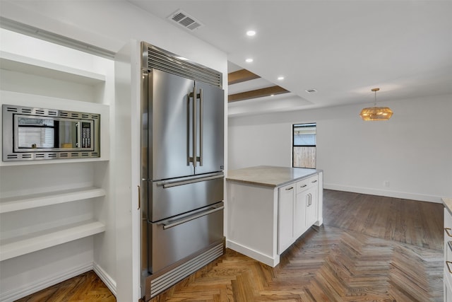 kitchen featuring recessed lighting, visible vents, white cabinetry, high end fridge, and light countertops