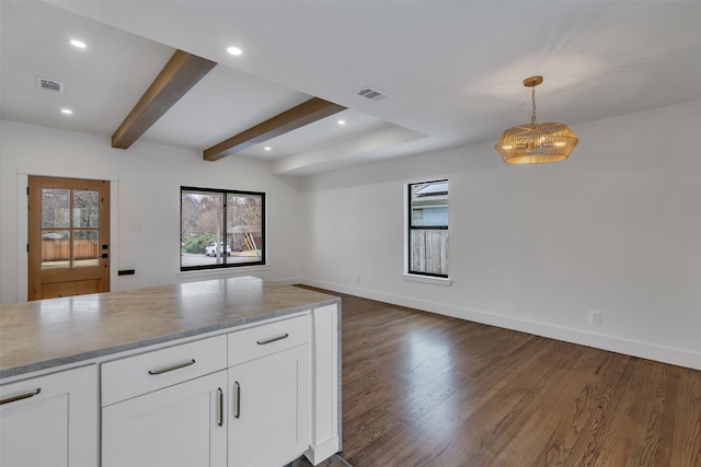 kitchen with dark wood-style floors, beam ceiling, visible vents, and open floor plan