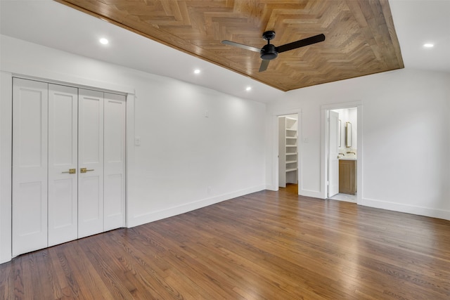 unfurnished bedroom featuring recessed lighting, a closet, baseboards, and wood finished floors