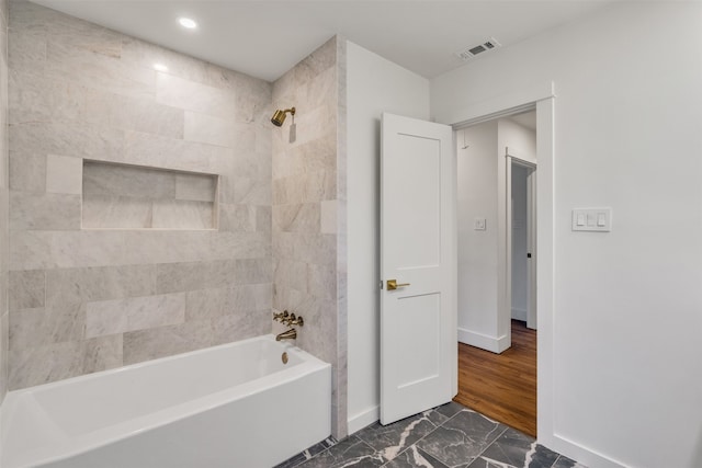 full bath featuring bathtub / shower combination, visible vents, marble finish floor, and baseboards