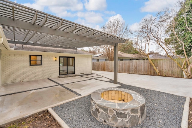 view of patio featuring a fire pit and fence